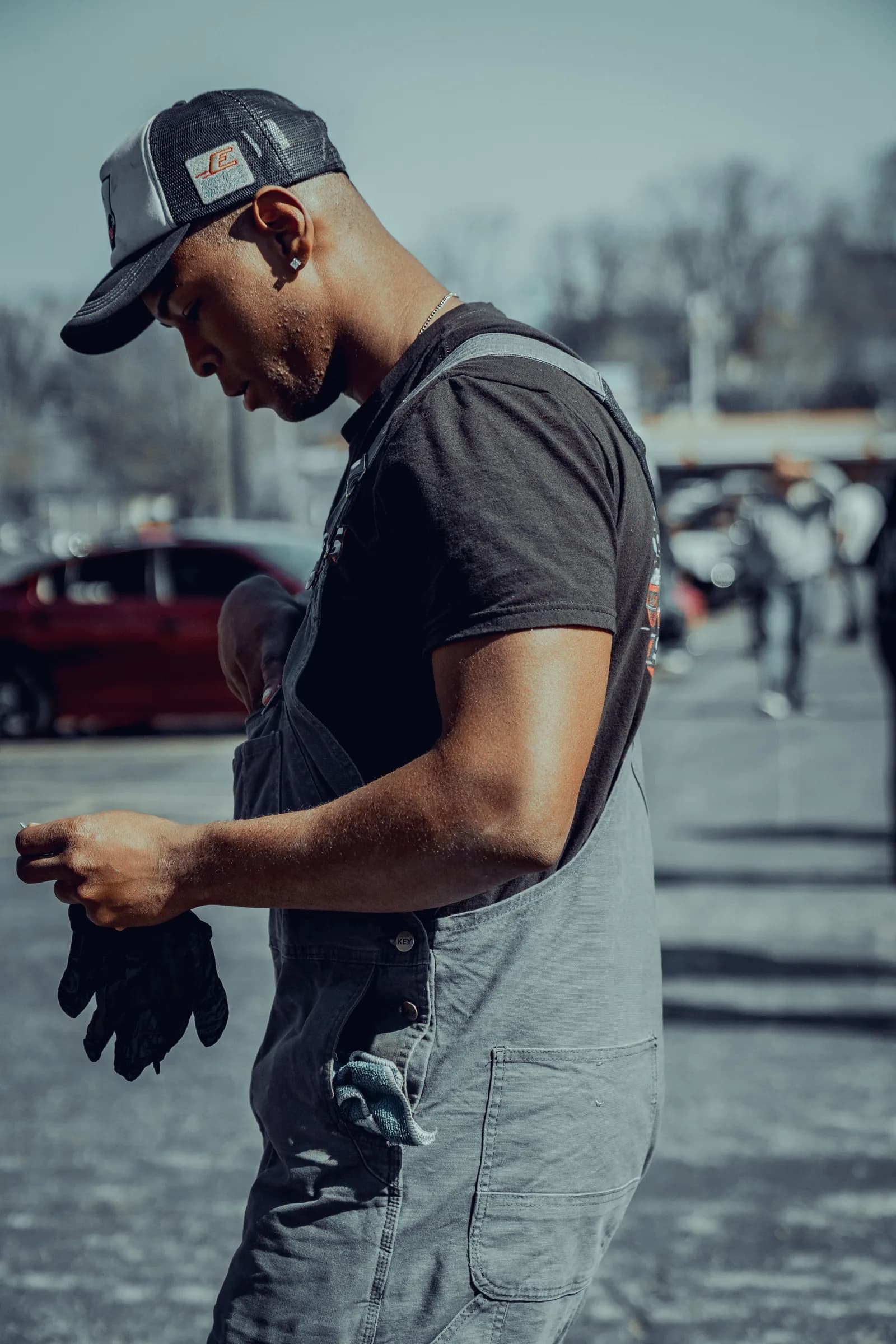 Devin Lee, owner and operator of Showroom Shine, pulling off his work gloves after a detail
